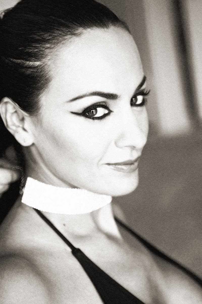 Illustrative black and white stock portrait of an adult wearing a light choker